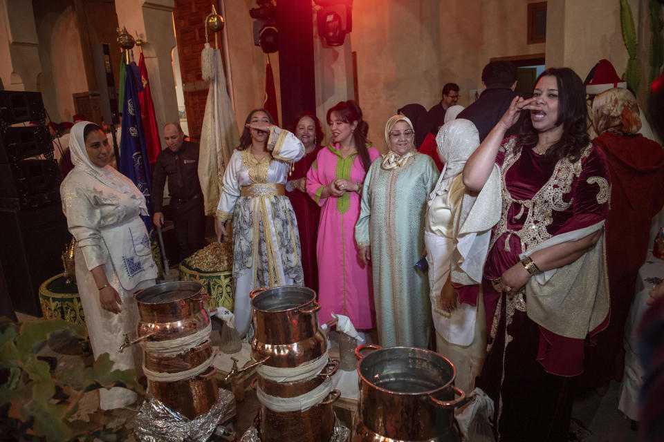 Women ululate in celebration after distilling orange blossoms in a cultural center in Marrakech, Morocco, Saturday, March 23, 2024. Moroccan cities are heralding in this year's spring with orange blossoms by distilling them using traditional methods. Orange blossom water is mostly used in Moroccan pastries or mint tea and sprinkled over heads and hands in religious ceremonies. (AP Photo/Mosa'ab Elshamy)