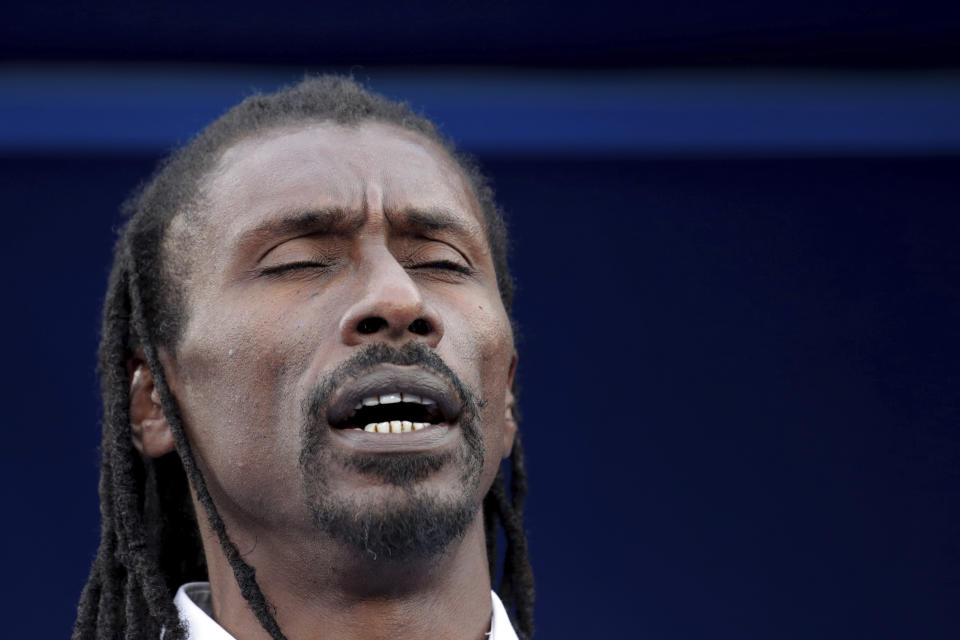 Senegal's head coach Aliou Cisse team lines up for the anthems before the African Cup of Nations semifinal soccer match between Senegal and Tunisia in 30 June stadium in Cairo, Egypt, Sunday, July 14, 2019. (AP Photo/Hassan Ammar)