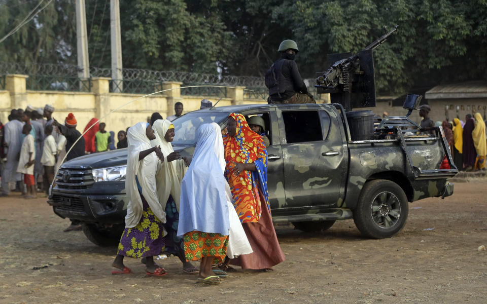 Parents are reunited with their daughters in Jangabe, Nigeria, Wednesday, March 3, 2021. More than 300 schoolgirls kidnapped last week in an attack on their school in northwest Nigeria have arrived in Jangabe after been freed on Tuesday. The Girls were abducted few days ago from Government Girls Secondary School in Jangabe in Zamfara state (AP Photo/Sunday Alamba)