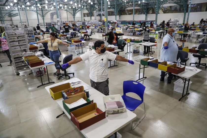 Industry, CA, Thursday, June 16, 2022 - LA County poll workers stretch during a break while processing mail-in ballots. (Robert Gauthier/Los Angeles Times)