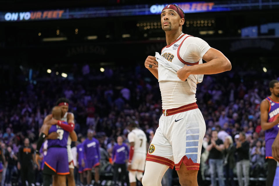 Denver Nuggets forward Zeke Nnaji removes his jersey after an NBA basketball game against the Phoenix Suns, Friday, March 31, 2023, in Phoenix. The Suns defeated the Nuggets 100-93. (AP Photo/Matt York)