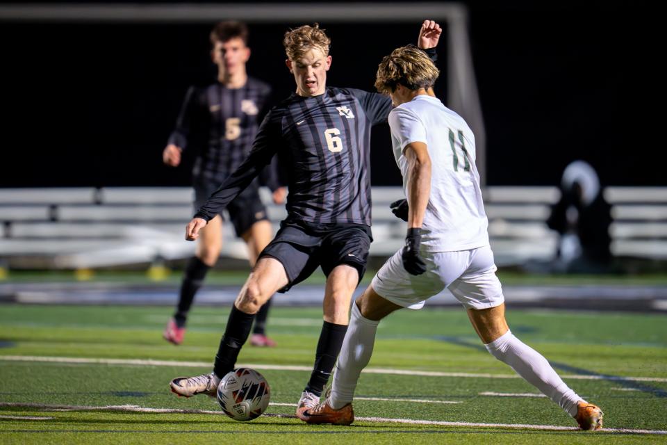 New Albany's Adam Hoy (6) takes on Dublin Jerome's Jake Ziolo (11) during a Division I regional semifinal Wednesday night at Hilliard Bradley.