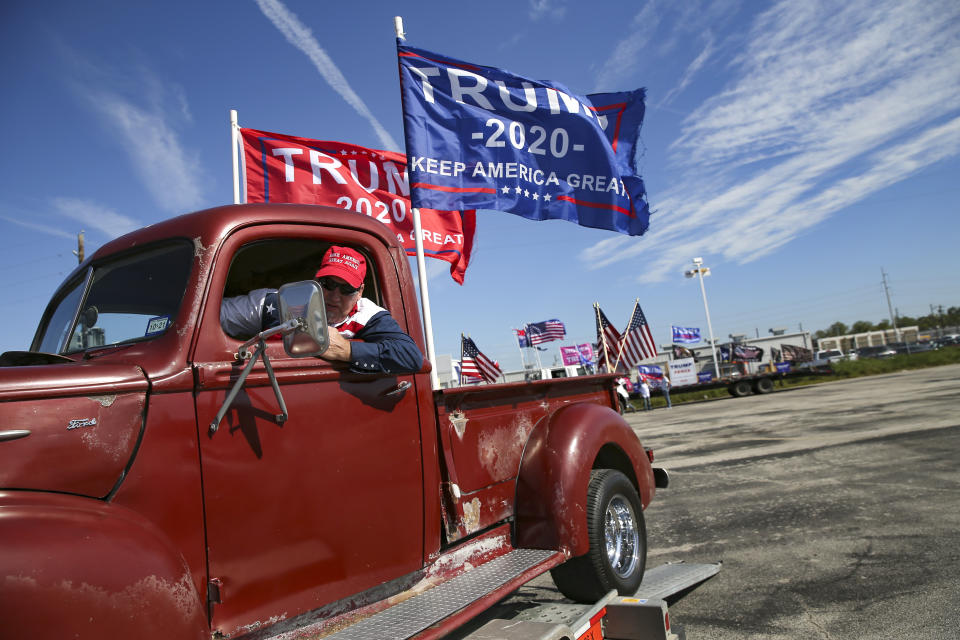 Mike Howell of Coolidge, Texas puts his 1942 Ford F-1 truck back on a trailer after participating in a Trump support rally drive around the 610 loop in Houston on Sunday, Nov. 1, 2020. (Elizabeth Conley/Houston Chronicle via AP)