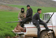 Turkish-backed Free Syrian Army fighters sit at a back of a pick-up truck near the city of Afrin, Syria February 21, 2018. REUTERS/Khalil Ashawi