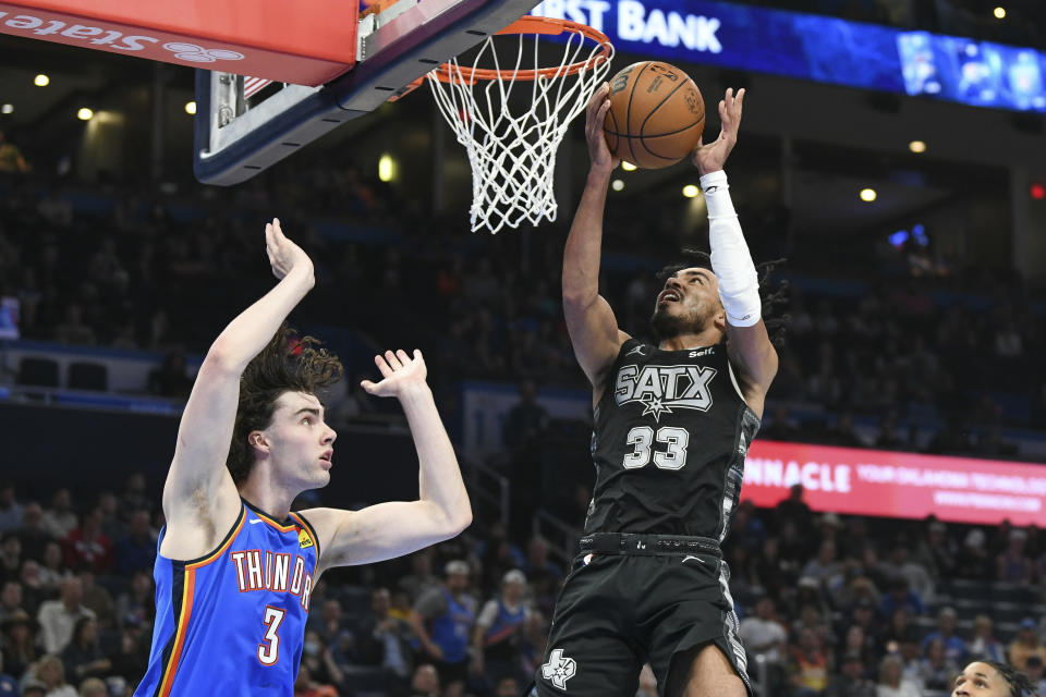 San Antonio Spurs guard Tre Jones (33) shoots over Oklahoma City Thunder guard Josh Giddy (3) in the second half of an NBA basketball game, Wednesday, April 10, 2024, in Oklahoma City. (AP Photo/Kyle Phillips)