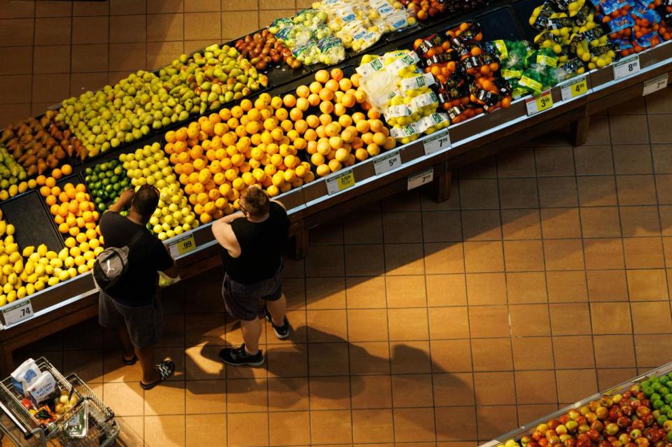 People shop in the produce aisle of a grocery store in Toronto, Monday, July 17, 2023.  