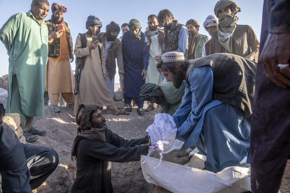 An Afghan man buries his little grandson who was killed by the earthquake, in a village in Zenda Jan district in Herat province, western of Afghanistan, Monday, Oct. 9, 2023. Saturday's deadly earthquake killed and injured thousands when it leveled an untold number of homes in Herat province. (AP Photo/Ebrahim Noroozi)