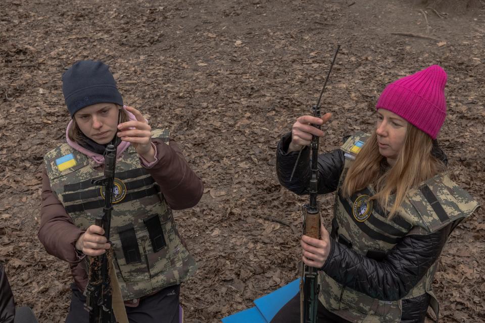 Ukrainian civilian women learn how to assemble and disassemble weapons as they attend a training for women focused on the use of weapons and combat medical kit in Kyiv on March 16, 2024.