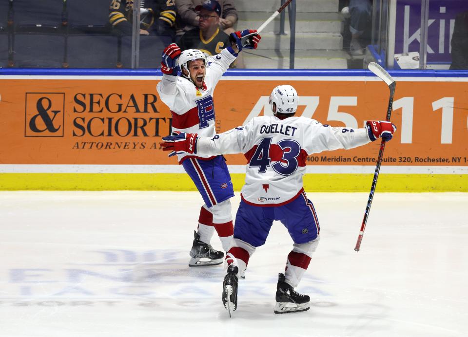 Laval's Jean-Sebastien Dea celebrates his game winning goal with teammate Xavier Ouellet.  The Rocket won 6-5 in the 3rd overtime to win the North Division Final series.