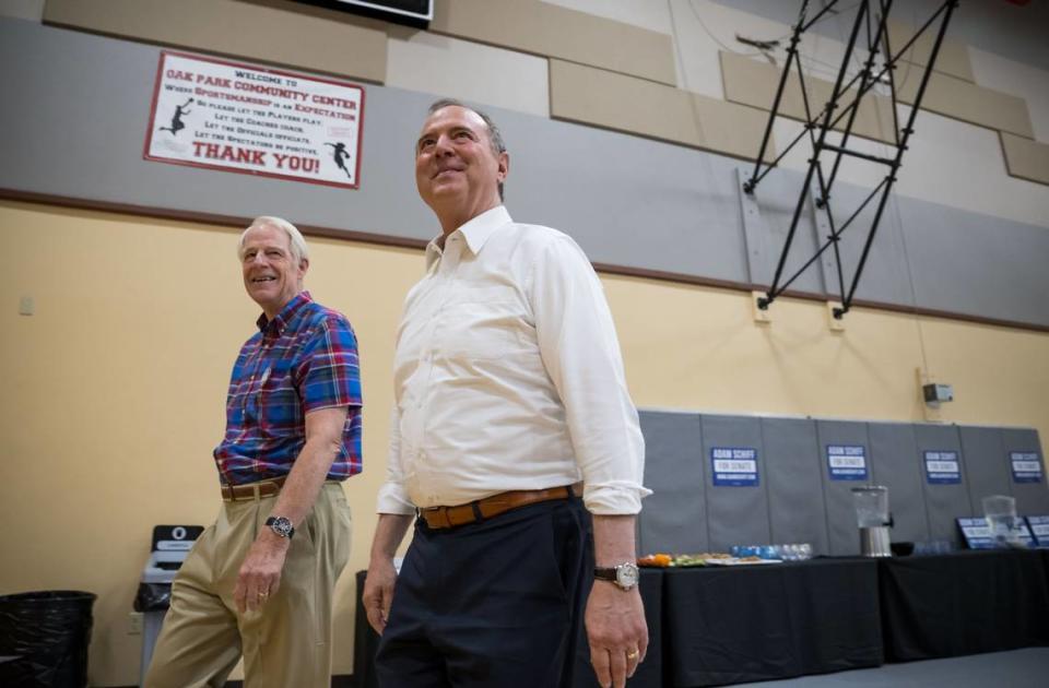 U.S. Rep. Adam Schiff, right, walks towards the audience accompanied by former California Assemblyman Roger Dickinson, who later introduces him, at a town hall event hosted by the Women Democrats of Sacramento County on Aug. 4 at the Oak Park Community Center.
