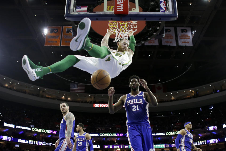 Boston Celtics' Aron Baynes dunks as Philadelphia 76ers' Joel Embiid (21) watches during the first half of an NBA basketball game Wednesday, March 20, 2019, in Philadelphia. (AP Photo/Matt Slocum)