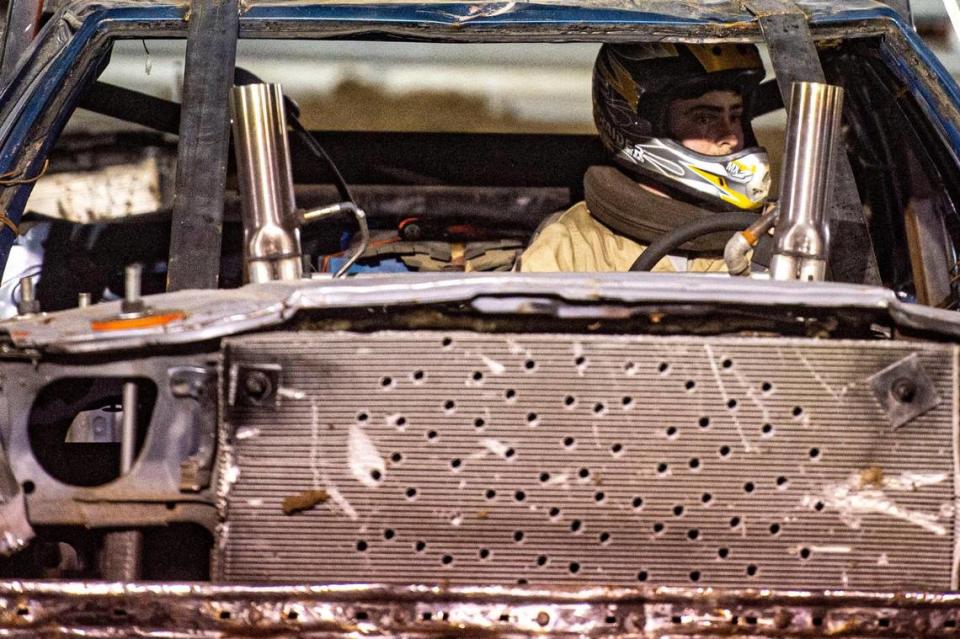 Berkley Lindsey watches out for other drivers while competing in the demolition derby at the Platte County Fair, Thursday, July 22, 2021, in Tracy, Missouri.