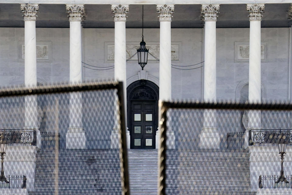 Fencing is placed around the exterior of the Capitol grounds, Thursday, Jan. 7, 2021 in Washington. The House and Senate certified the Democrat's electoral college win early Thursday after a violent throng of pro-Trump rioters spent hours Wednesday running rampant through the Capitol. A woman was fatally shot, windows were bashed and the mob forced shaken lawmakers and aides to flee the building, shielded by Capitol Police. (AP Photo/John Minchillo)