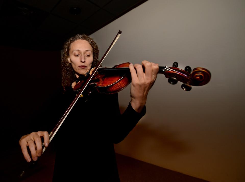 Yona Stamatis plays one of the violins Wednesday, that survived the Holocaust and will be part of the concert given at the Illinois State Museum Thursday. Stamatis is associate professor of ethnomusicology at the University of Illinois Springfield.