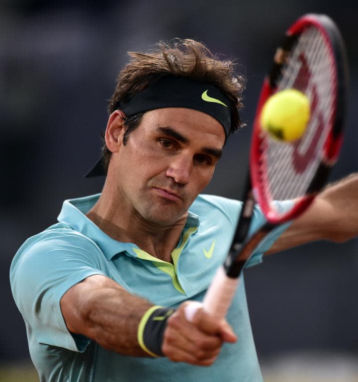 Roger Federer of Switzerland returns a ball to Nick Kyrgios of Australia during the Madrid Open, at the Caja Magica (Magic Box) sports complex, on May 6, 2015