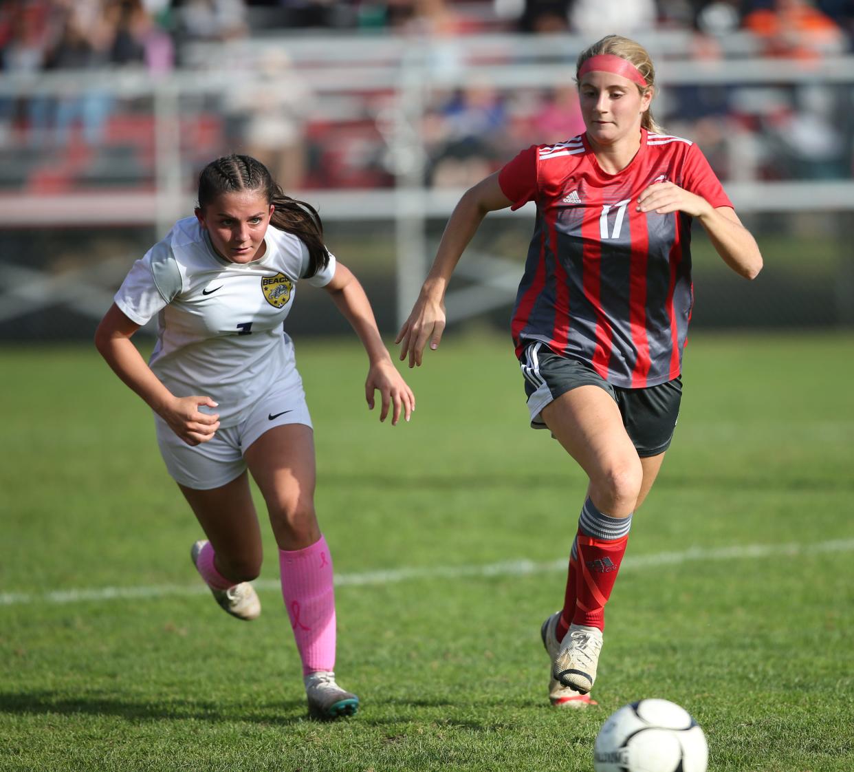 Beacon's Reilly Landisi and Red Hook's Molly Button chase down the ball during Wednesday's Section 9 Class A girls soccer semifinal on October 25, 2023.