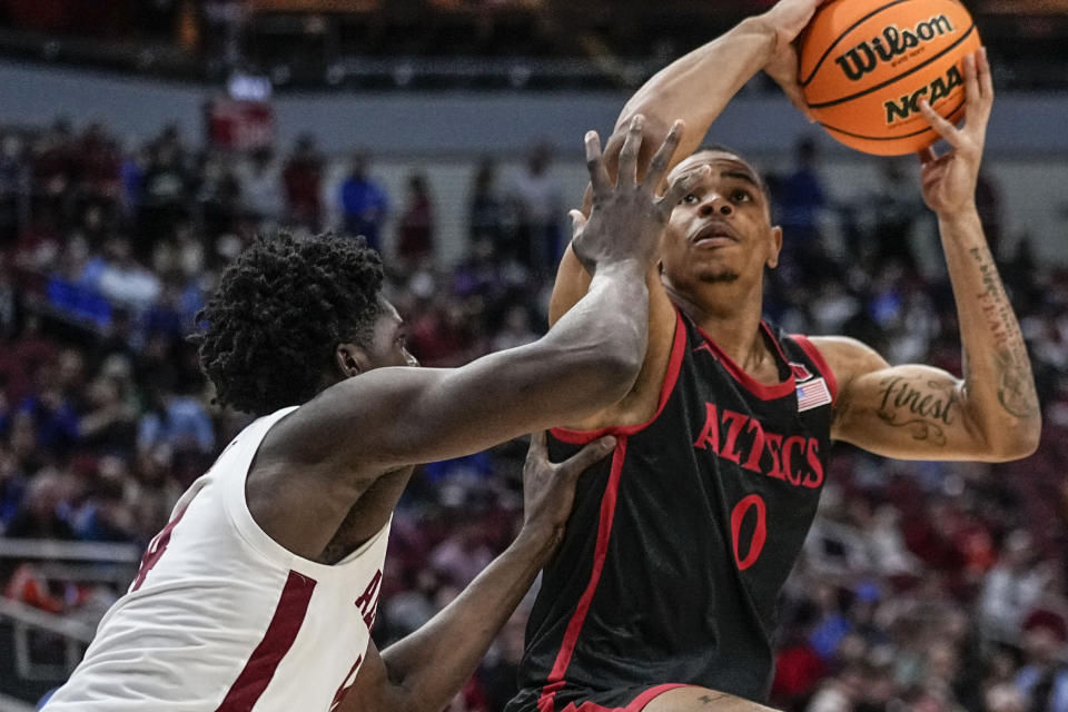 San Diego State forward Keshad Johnson (0) shoots against Alabama center Charles Bediako (14) in the second half of a Sweet 16 round college basketball game in the South Regional of the NCAA Tournament, Friday, March 24, 2023, in Louisville, Ky. (AP Photo/John Bazemore)