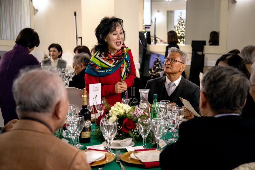 LOS ANGELES, CA - DECEMBER 22, 2022: Board member Karin Kim, 68, of Torrance greets other alumni during the end-of-year alumni gathering of Seoul Arts High School's LA chapter at Aroma Spa & Sports on December 22, 2022 in Los Angeles, California. (Gina Ferazzi / Los Angeles Times)