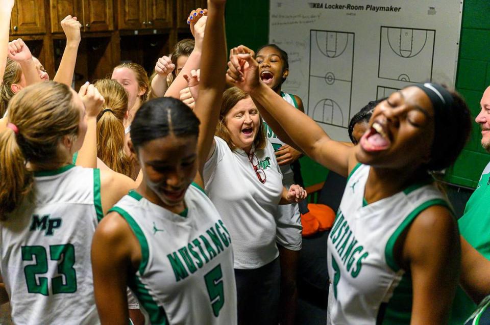 Myers Park celebrates a win over Butler Tuesday and coach Barbara Nelson’s 700th win Sabian Touissant/Special to the Observer