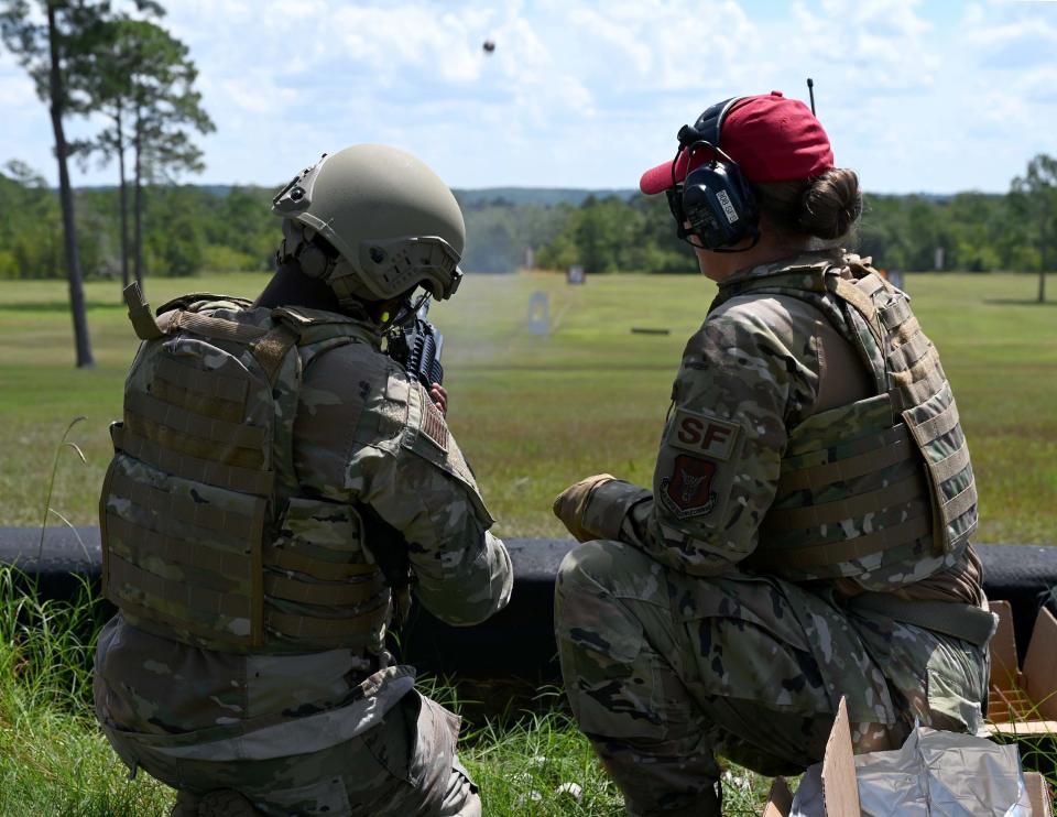 From left, Senior Airman Candace Ross, a 908th Security Forces Squadron defender, fires an M203 grenade launcher while Tech. Sgt. Joy White, 908 SFS combat arms training and maintenance instructor, oversees the firing Aug. 6, 2022, at Fort Rucker, Alabama. The M203 grenade launcher is a single shot, under-barrel grenade launcher that attaches to the M16 or M4 carbine.