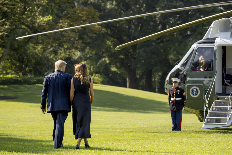 President Donald Trump and first lady Melania Trump walk across the South Lawn of the White House in Washington, Wednesday, Aug. 7, 2019, to board Marine One for a short trip to Andrews Air Force Base, Md., and then on to Dayton, Ohio, and El Paso, Texas, in the afternoon to praise first responders and console family members and survivors from two recent mass shootings. (AP Photo/Andrew Harnik)