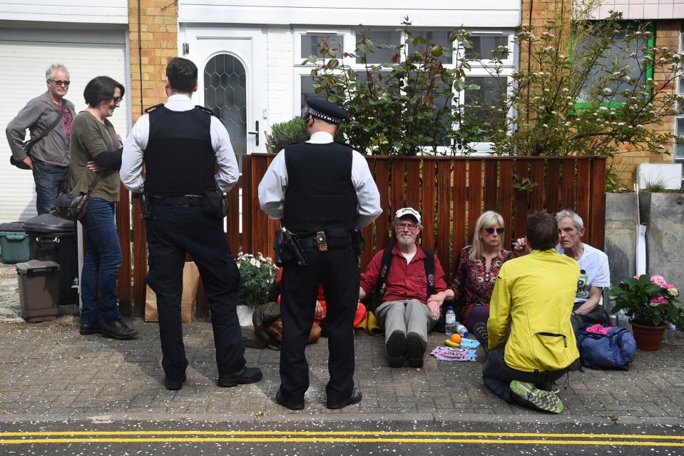 Police officers talk with climate activist who have glued themselves together outside Labour Party leader Jeremy Corbyn's house in north London (PA)