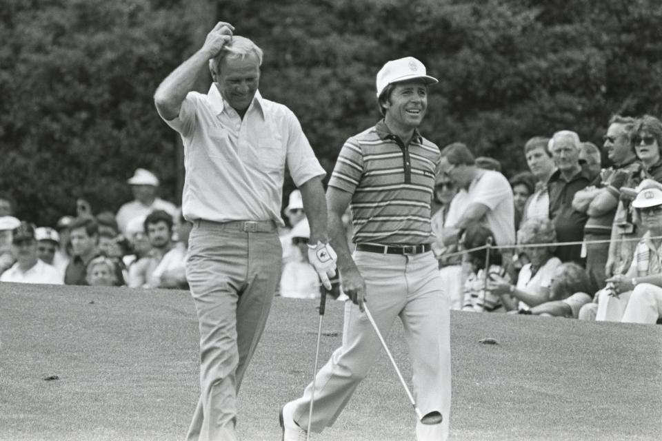 Arnold Palmer and Gary Player walk down a fairway during the 1981 Masters at Augusta National.