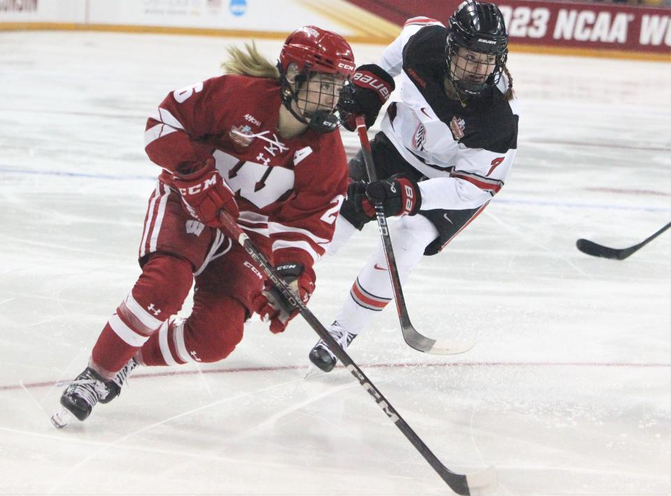 Wisconsin's Casey O'Brien (26) moves the puck past Ohio State's Emma Peschel (7) during the NCAA Division I women's hockey final last season. Both players will be on the ice in the title game Sunday.