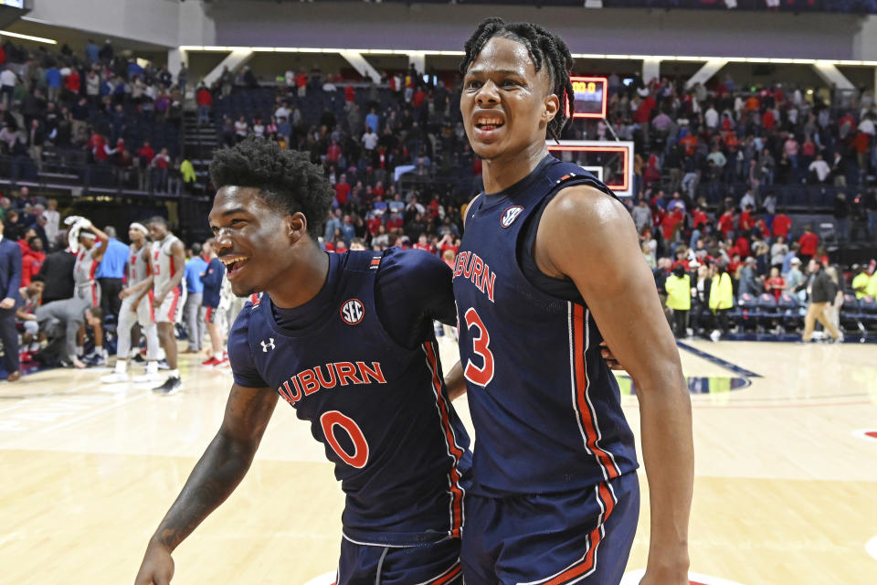 Auburn guard Tyrell Jones (0) and forward Isaac Okoro (23) react after the team's 83-82 double-overtime win over Mississippi in an NCAA college basketball game in Oxford, Miss., Tuesday, Jan. 28, 2020. (AP Photo/Thomas Graning)