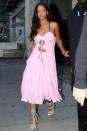 <p>Showing off her girly side in a bubblegum pink cut-out dress by Rosie Assoulin and baby blue lace-up sandals.</p>