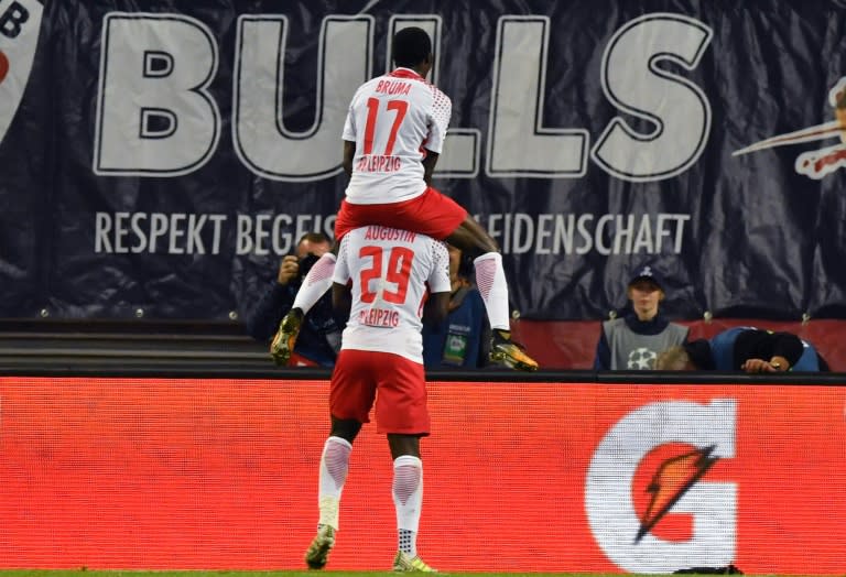 Leipzig´s Jean-Kevin Augustin (below) celebrates after scoring the 3-1 goal with his teammate Bruma during their Champions League match against FC Porto in Leipzig, eastern Germany on October 17, 2017