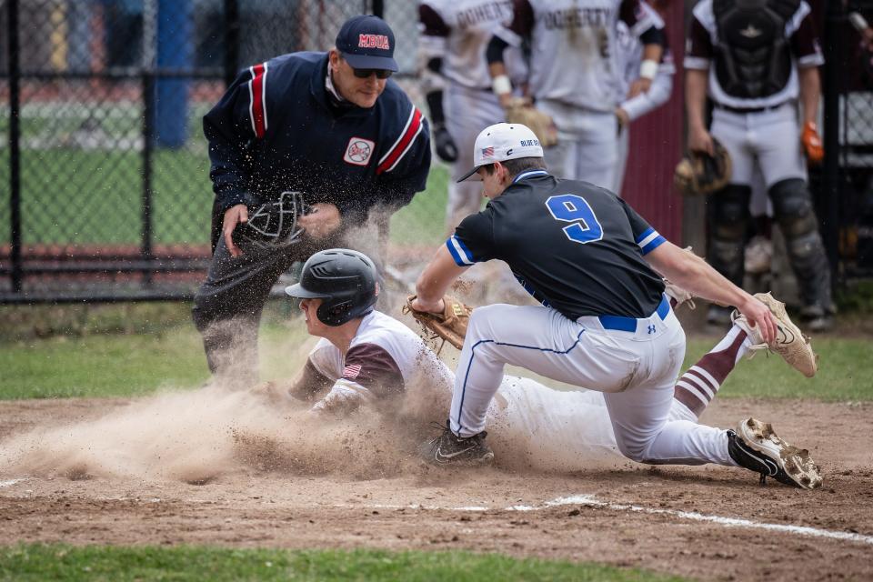 Doherty's Aiden Murphy steals home on a wild pitch ahead of the tag from Leominster's Mark Garner.