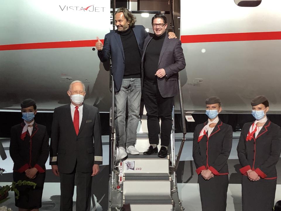 Flohr and Martel (center) celebrate in front of the new aircraft, with VistaJet staff nearby. - Credit: Courtesy Michael Verdon