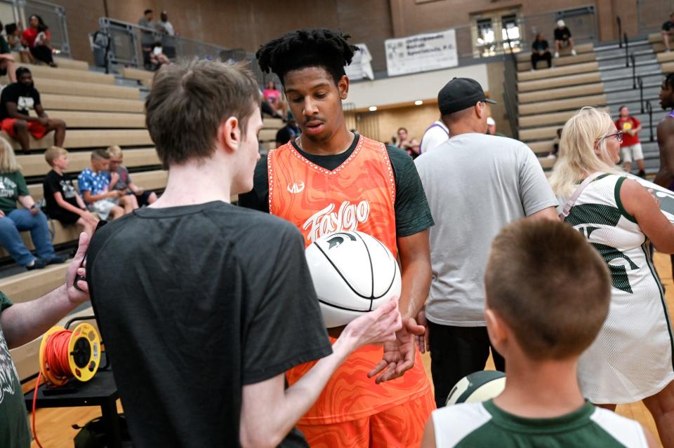 Michigan State's AJ Hoggard sings autographs for fans on Thursday, June 23, 2022, during the Moneyball Pro-Am at Holt High School.