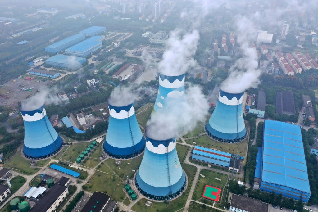 Steam billows out of the cooling towers at a coal-fired power station in Nanjing in east China's Jiangsu province. Global shoppers face possible shortages of smartphones and other goods ahead of Christmas (AP)