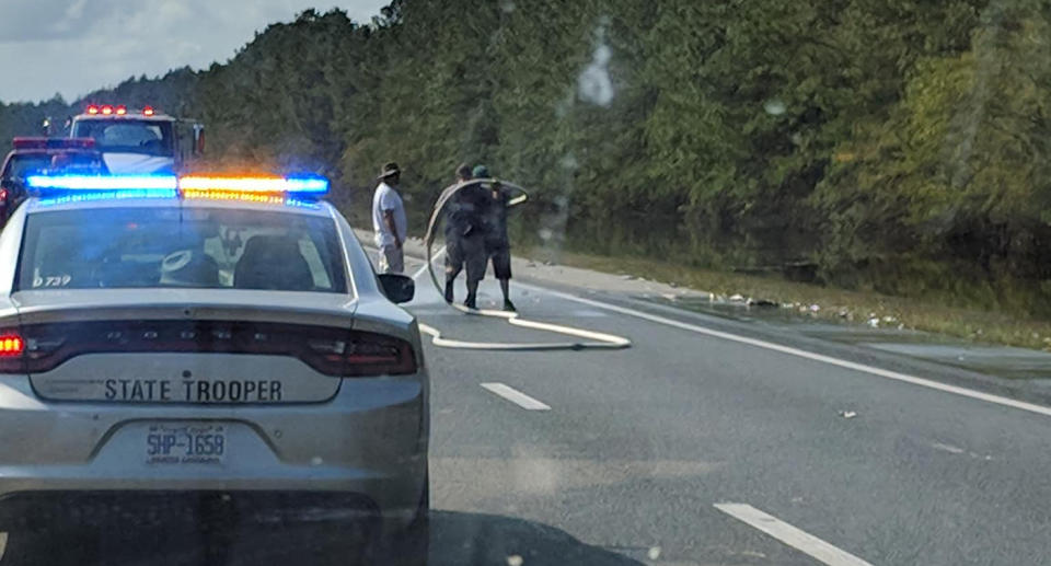 Hurricane Florence storm leaves dead fish for firefighters to clean up on North Carolina highway.