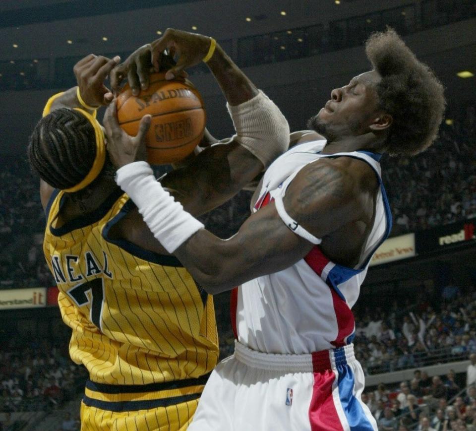 Pistons' Ben Wallace ties up Indiana Pacers' Jermaine O'Neal for a jump ball during the third  quarter in Game 6 of the Eastern Conference finals Tuesday, June 1, 2004, at the Palace of Auburn Hills.
