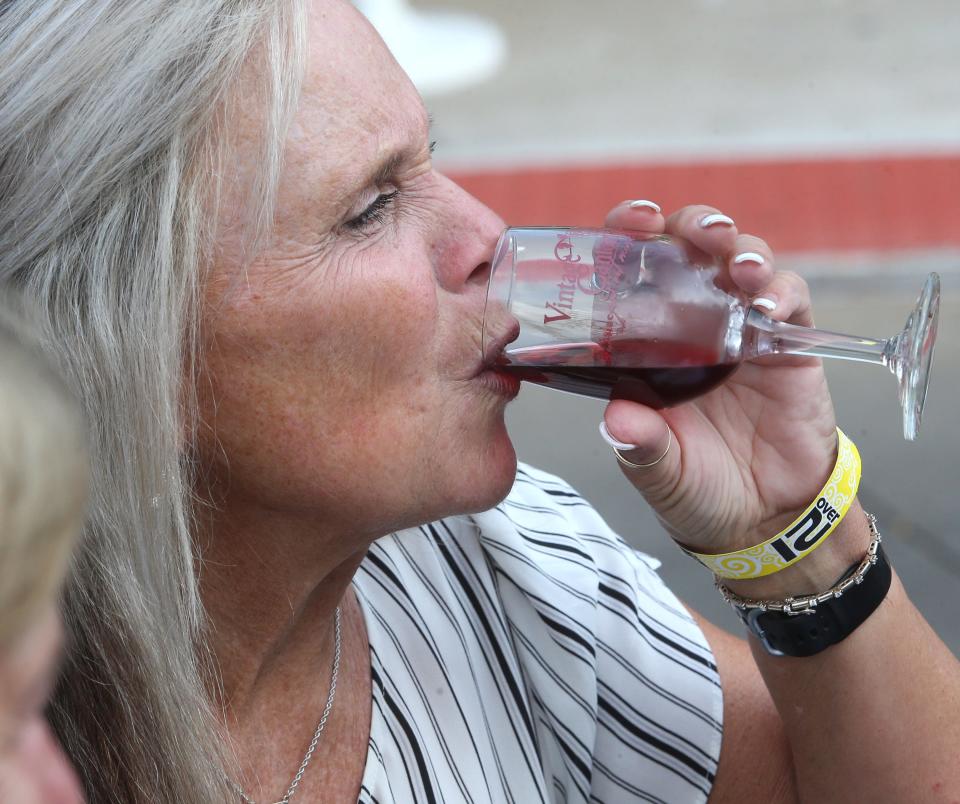 Kellie Straughn sampled a glass of wine during Vintage Canton on Thursday, Sept. 15, 2022.