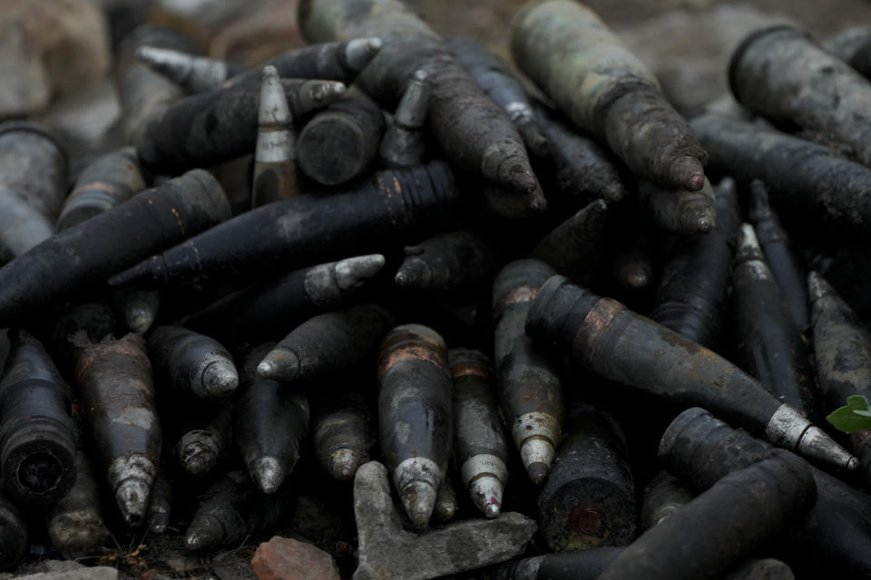 Weaponry lay beside a road near Makariv, on the outskirts of Kyiv, Ukraine, Tuesday, June 14, 2022. Russia’s invasion of Ukraine is spreading a deadly litter of mines, bombs and other explosive devices that will endanger civilian lives and limbs long after the fighting stops. (AP Photo/Natacha Pisarenko)