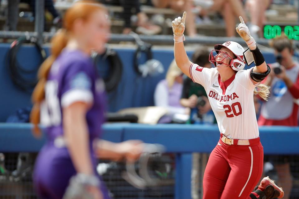 OU's Jana Johns (20) celebrates after hitting a grand slam in the fourth inning of a 13-2 win against Northwestern on Thursday.