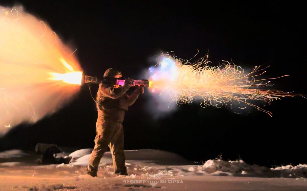 A Ukrainian soldier fires a shoulder-mounted rocket launcher