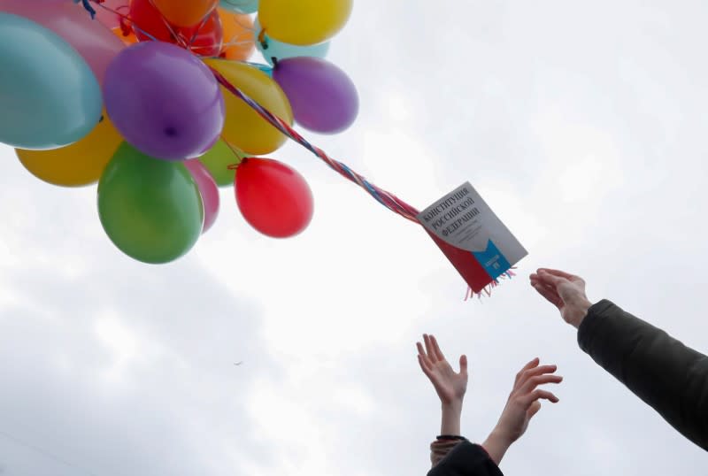 Activists release a copy of the Russia's constitution attached to balloons as they protest against constitutional reforms proposed by President Vladimir Putin, in Saint Petersburg