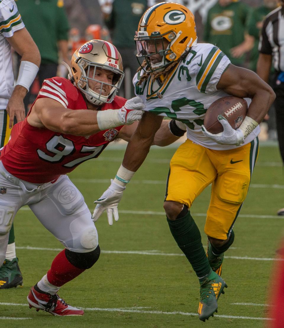 San Francisco 49ers defensive end Nick Bosa #97 tackles Green Bay Packers running back Aaron Jones #33 on Sunday, September 26, 2021, at Levis Stadium in Santa Clara, California. The Packers defeated the 49ers 30-28.