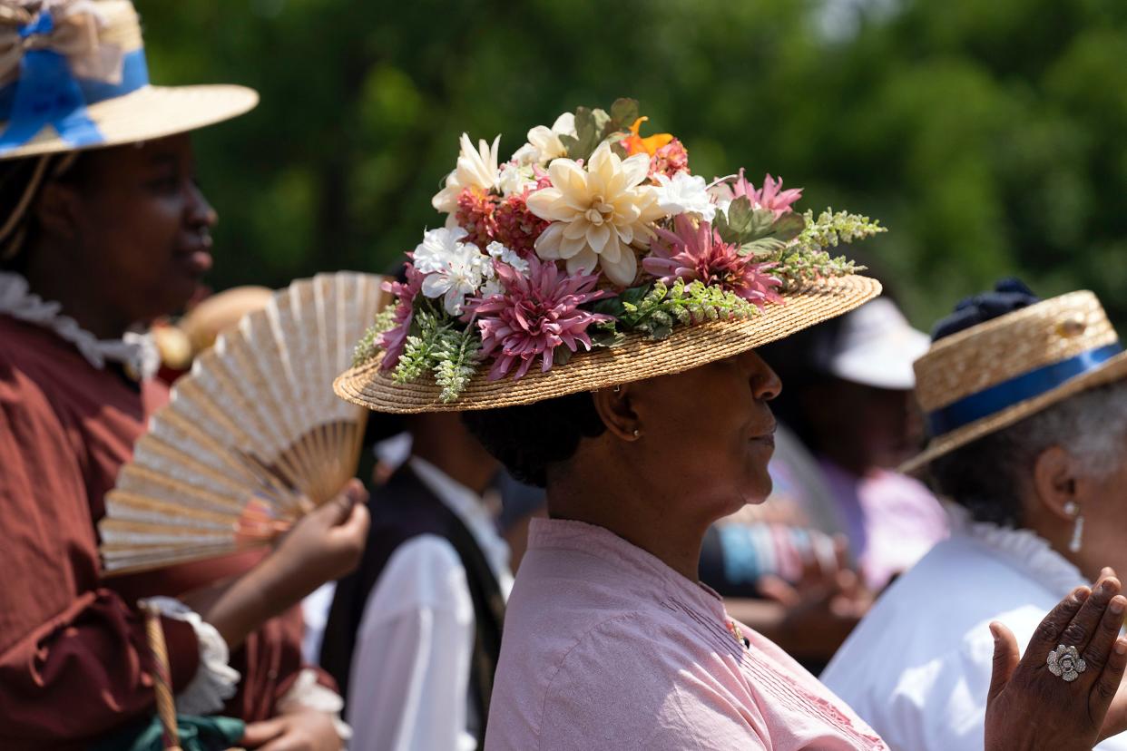 Jun 18, 2023; Columbus, OH, USA; Anita Davis, dressed as Ethel Williams, applauds during the Juneteenth Jubilee Day Festival in the Ohio Village on the grounds of the Ohio History Center. 