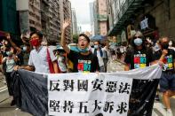 Pan-democratic legislator Eddie Chu Hoi-dick, Vice convener for Hong Kong's Civil Human Rights Front Figo Chan and activist Leung Kwok-hung march at the anniversary of Hong Kong's handover to China from Britain, in Hong Kong