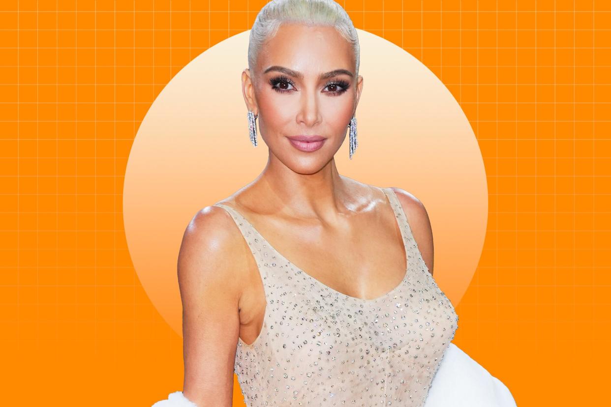 Kim Kardashian wearing her 2022 Met Gala dress on a designed background