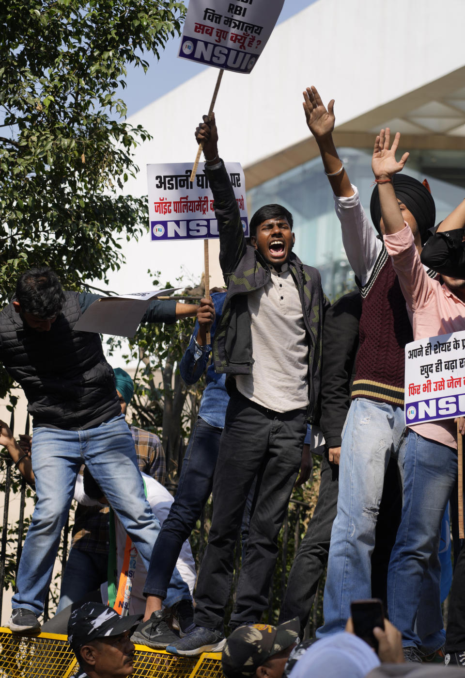 Members of opposition Congress party’s student wing demanding an investigation into allegations of fraud and stock manipulation by India's Adani Group shout slogans atop a police barricade during a protest in New Delhi, India, Monday, Feb.6, 2023. The Congress party urged people to protest, adding to pressure on Prime Minister Narendra Modi to respond to a massive sell-off of shares in Adani Group companies after a U.S.-based short-selling firm, Hindenburg Research, accused them of various fraudulent practices. The Adani group has denied any wrongdoing. (AP Photo/Manish Swarup)