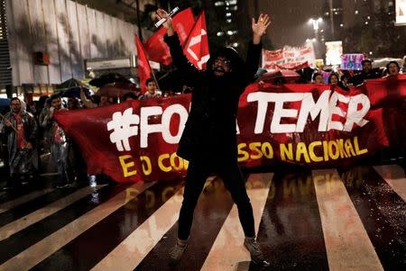 Demonstrators take part in a protest against Brazil's President Michel Temer in Sao Paulo, Brazil, May 18, 2017. The banner reads "Out Temer." REUTERS/Nacho Doce