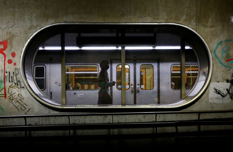 A woman wearing a protective mask walks along an underground platform during the second lockdown as the coronavirus disease continues in Vienna