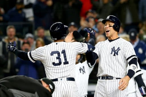 Aaron Hicks #31 of the New York Yankees celebrates with teammate after hitting a three-run home run in the first inning of the Yankees' 4-1 win over the Houston Astros in game five of Major League Baseball's American League Championship Series